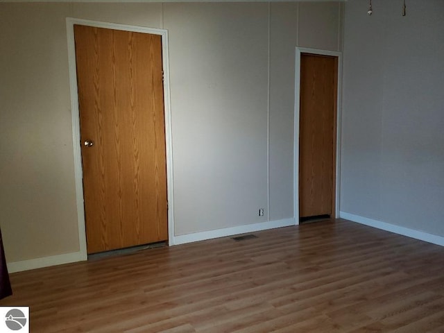 spare room with hardwood / wood-style floors