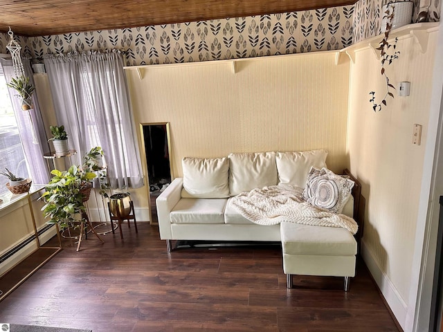 living room with a baseboard heating unit and dark wood-type flooring