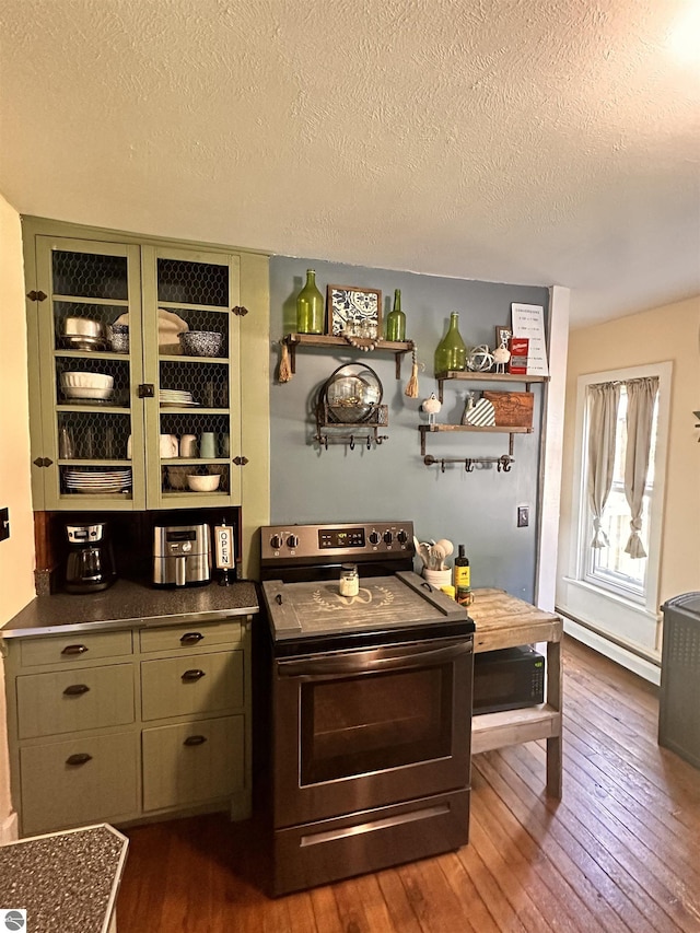 bar with dark hardwood / wood-style flooring, electric stove, a textured ceiling, and green cabinetry