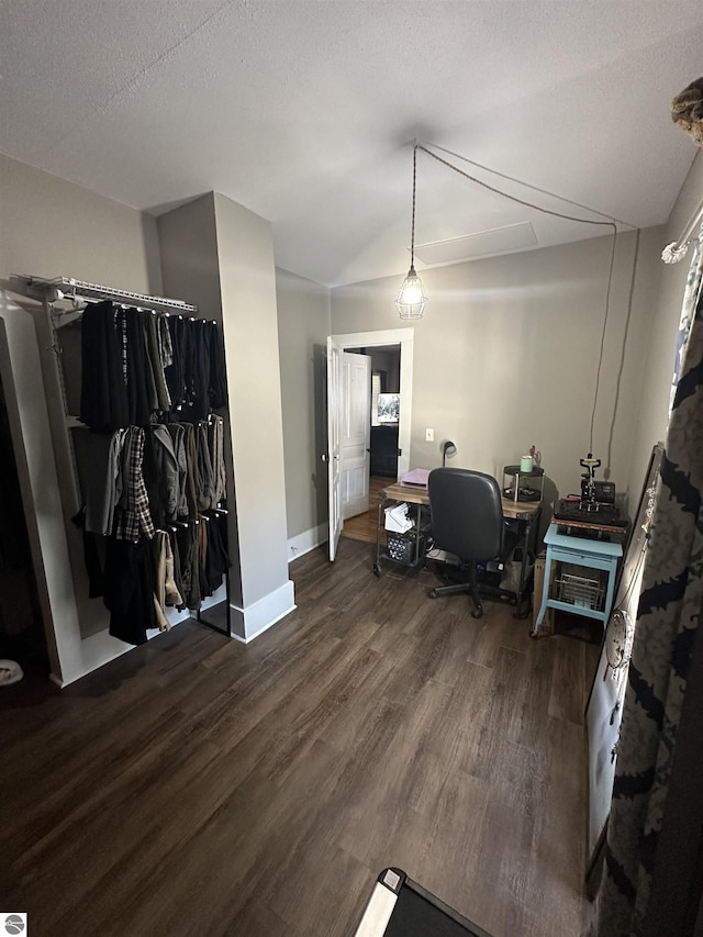 home office featuring dark hardwood / wood-style floors and a textured ceiling