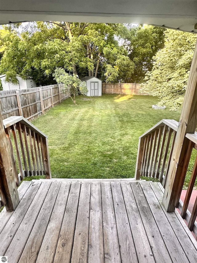 view of yard with a storage shed and a wooden deck