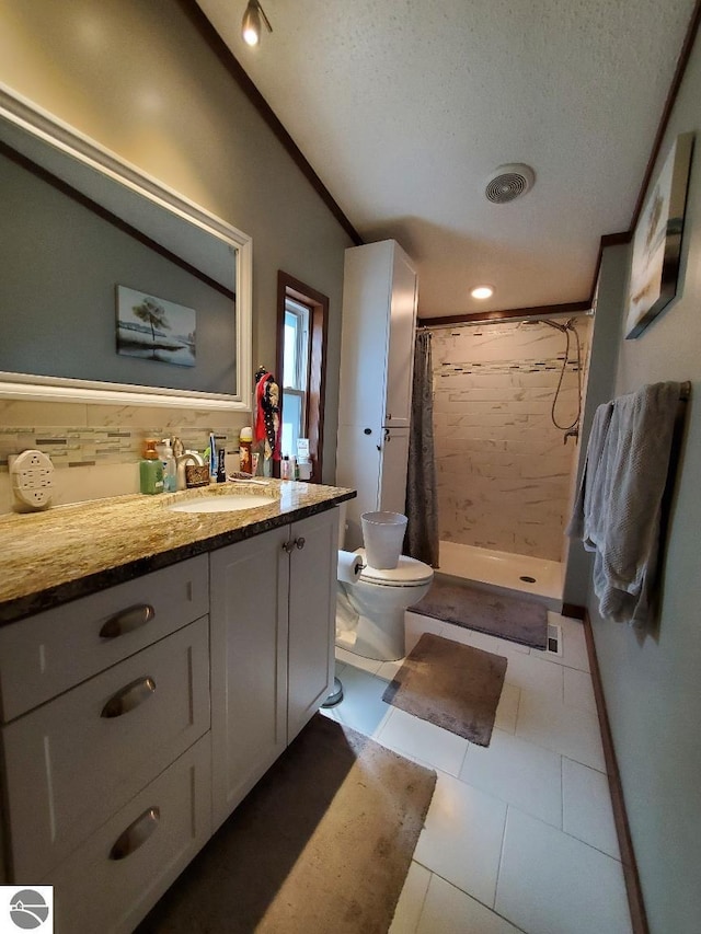 bathroom with toilet, vanity, a textured ceiling, and a shower with shower curtain