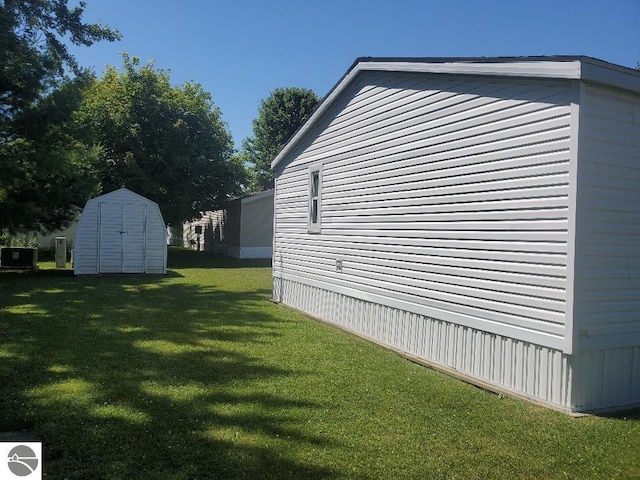 view of home's exterior with a shed and a lawn