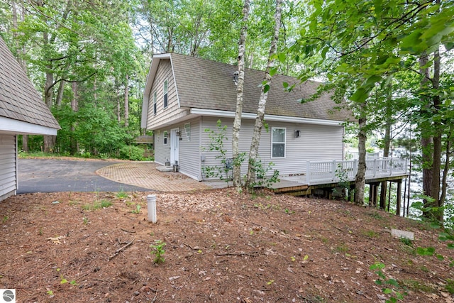 view of side of home with a wooden deck