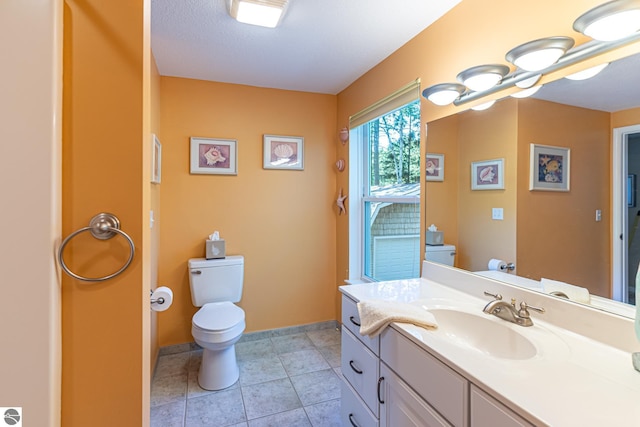 bathroom with tile patterned floors, vanity, and toilet