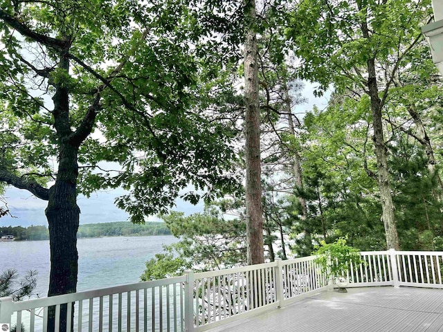 wooden terrace featuring a water view