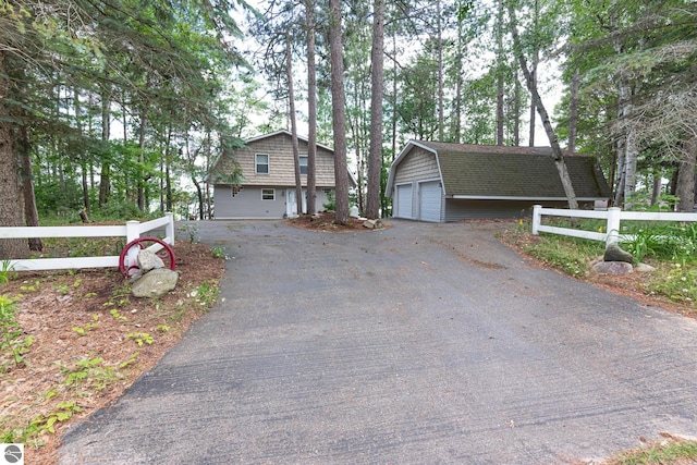 view of front of house featuring a garage and an outdoor structure