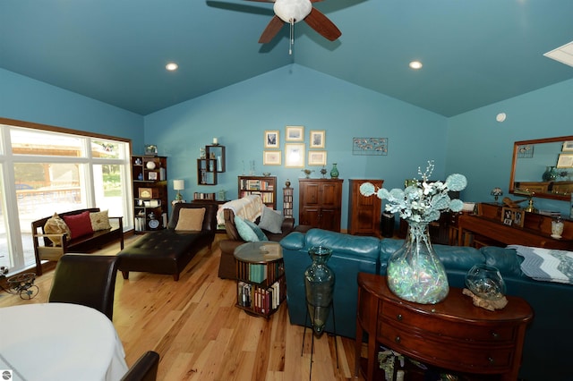 living room with wood-type flooring, ceiling fan, and vaulted ceiling