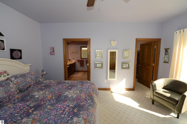 bedroom featuring carpet floors, ceiling fan, and connected bathroom