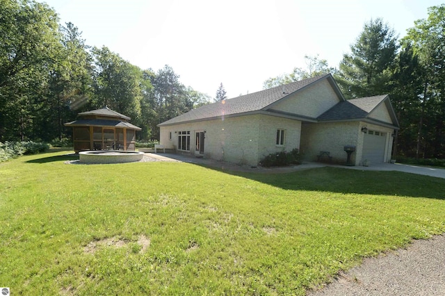 view of side of property with a garage and a lawn