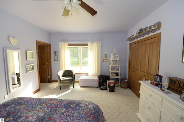 carpeted bedroom featuring a closet and ceiling fan