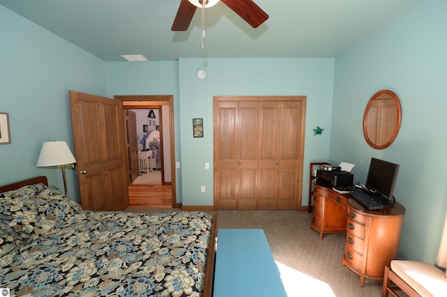 carpeted bedroom featuring ceiling fan and a closet