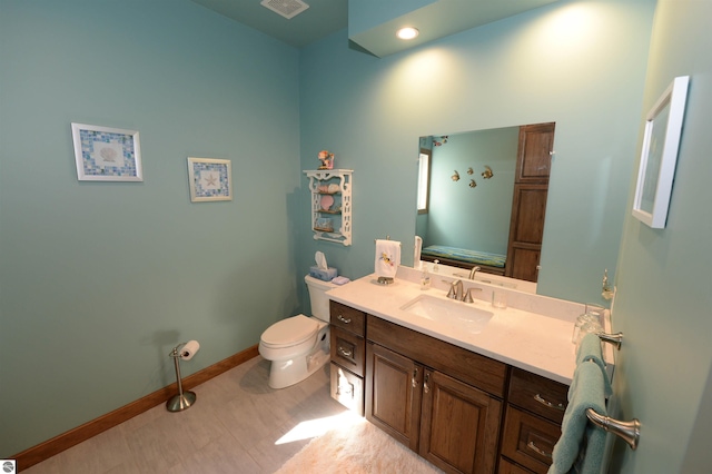 bathroom featuring vanity, tile patterned floors, and toilet