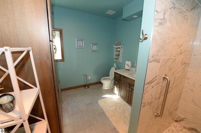 bathroom featuring vanity, tile patterned floors, and toilet