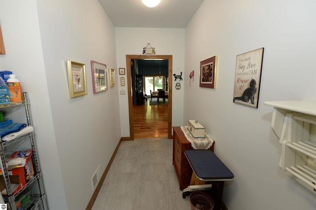 corridor featuring wood-type flooring