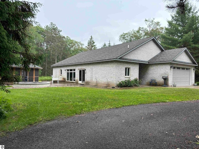 view of side of property featuring a garage and a yard