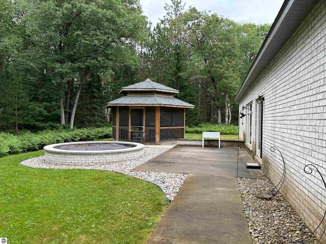 view of yard featuring a sunroom and a patio