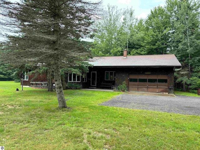 view of front of home featuring a garage and a front lawn