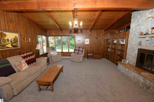 living room featuring vaulted ceiling with beams, wooden walls, wood ceiling, a stone fireplace, and carpet flooring