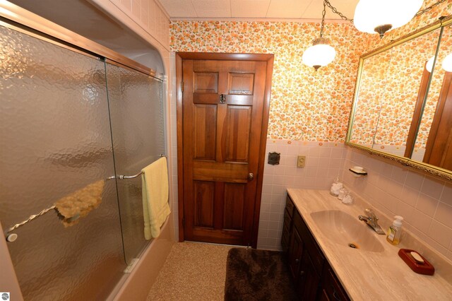 bathroom with vanity, decorative backsplash, and tile walls