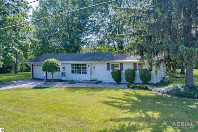 single story home featuring a garage and a front lawn