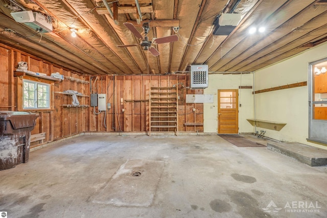 garage featuring wooden walls and a garage door opener