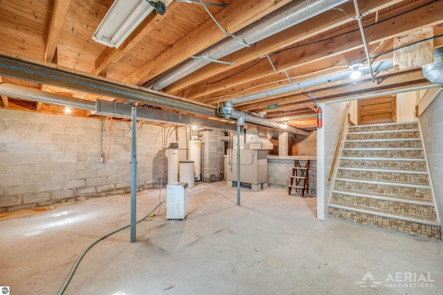 basement featuring gas water heater and heating unit