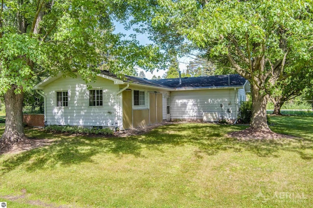 rear view of property with a lawn