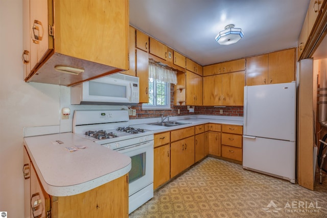 kitchen featuring kitchen peninsula, white appliances, tasteful backsplash, and sink