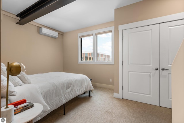 carpeted bedroom featuring a closet, beamed ceiling, and a wall unit AC