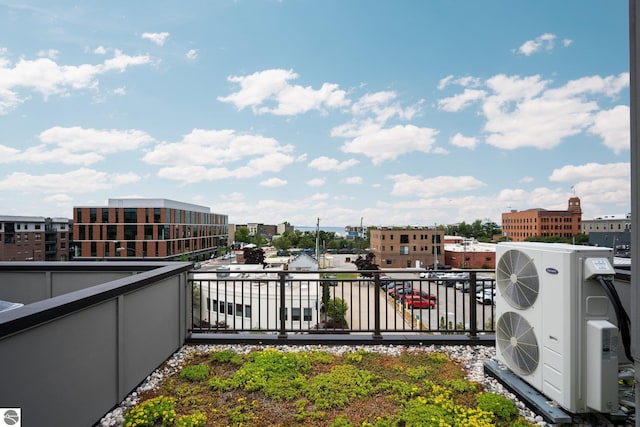 view of patio with a balcony and ac unit