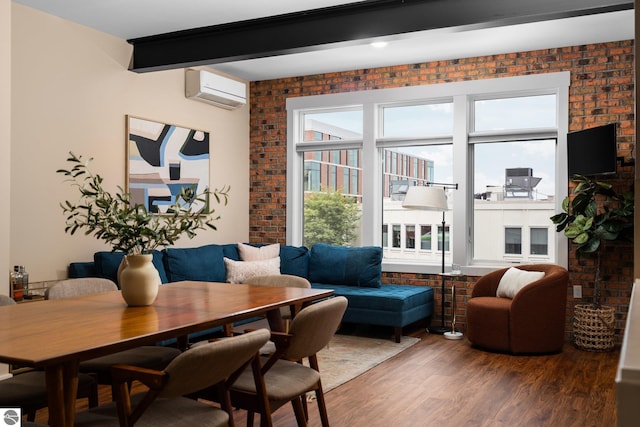 dining space featuring a wall mounted air conditioner, brick wall, beamed ceiling, and hardwood / wood-style floors