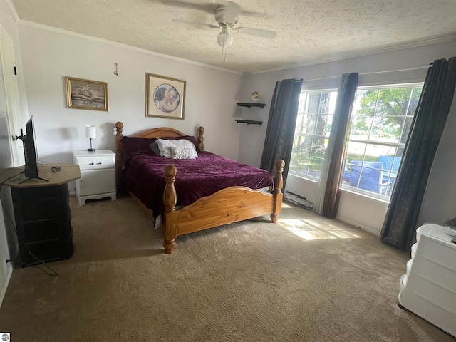 bedroom with carpet, a textured ceiling, ceiling fan, and crown molding