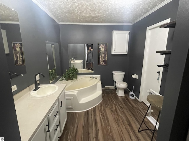 bathroom with hardwood / wood-style floors, vanity, a textured ceiling, and ornamental molding