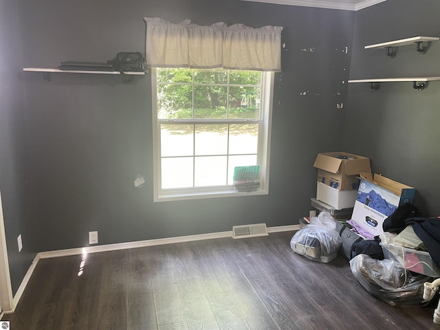 interior space with hardwood / wood-style flooring and ornamental molding