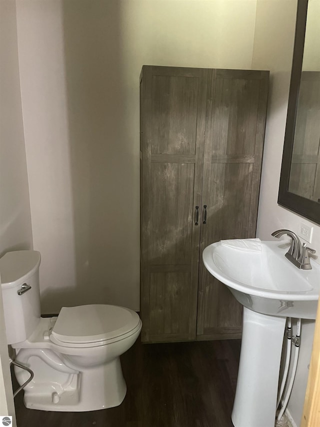 bathroom with sink, hardwood / wood-style floors, and toilet