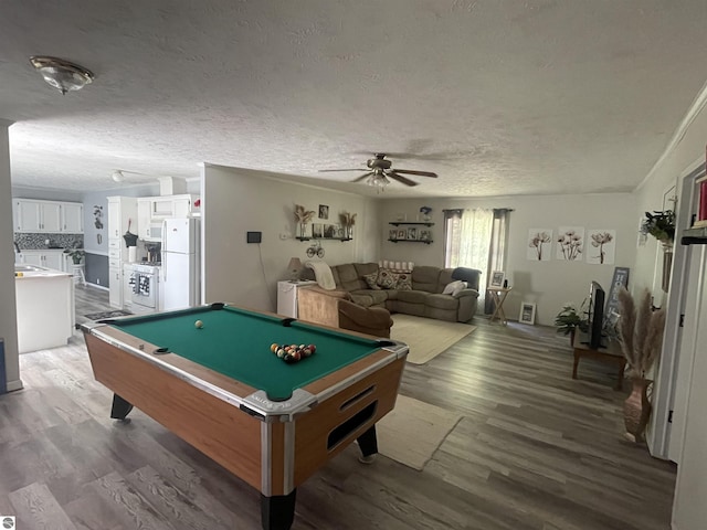 recreation room with a textured ceiling, ceiling fan, dark hardwood / wood-style floors, and pool table