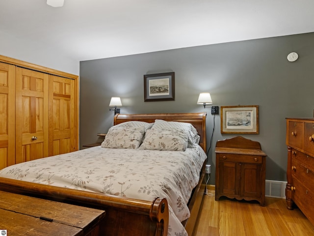 bedroom featuring a closet and light wood-type flooring