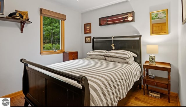 bedroom with hardwood / wood-style flooring