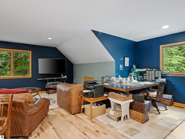 office with light hardwood / wood-style floors and vaulted ceiling