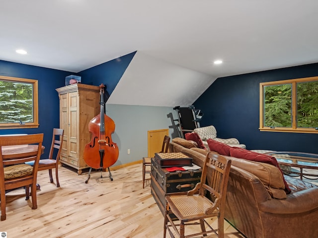 interior space with light hardwood / wood-style floors and lofted ceiling