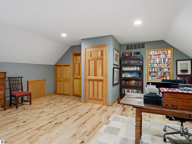 office area featuring light hardwood / wood-style floors and vaulted ceiling