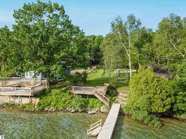 view of dock featuring a yard and a water view