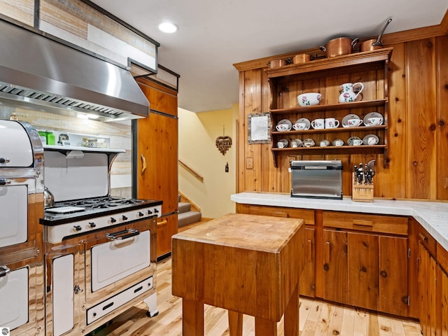 kitchen featuring light wood-type flooring, extractor fan, and a kitchen island