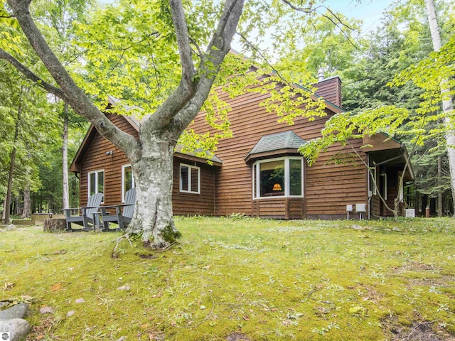 rear view of house with a yard