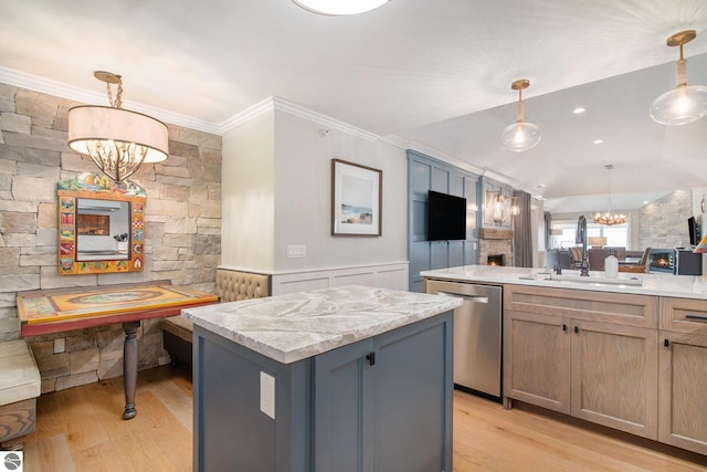 kitchen with a chandelier, stainless steel dishwasher, a center island, and decorative light fixtures