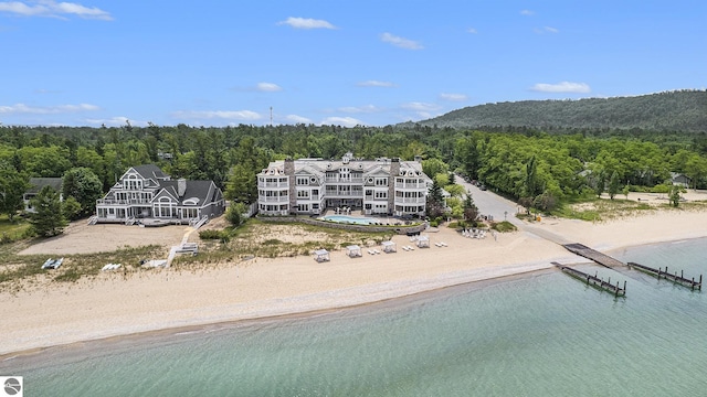 drone / aerial view with a water view and a beach view