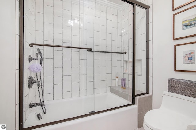 bathroom with shower / bath combination with glass door and toilet