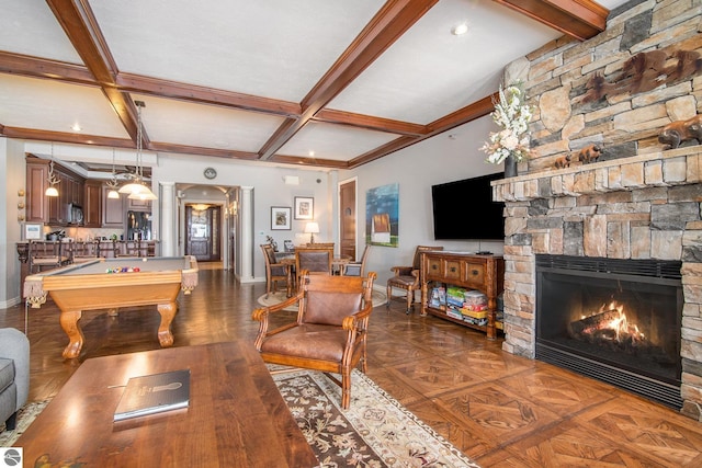 living room featuring beamed ceiling, coffered ceiling, dark wood-type flooring, a stone fireplace, and pool table