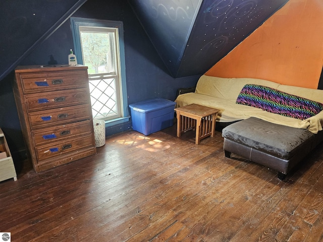 living area featuring hardwood / wood-style flooring, vaulted ceiling, and a wealth of natural light